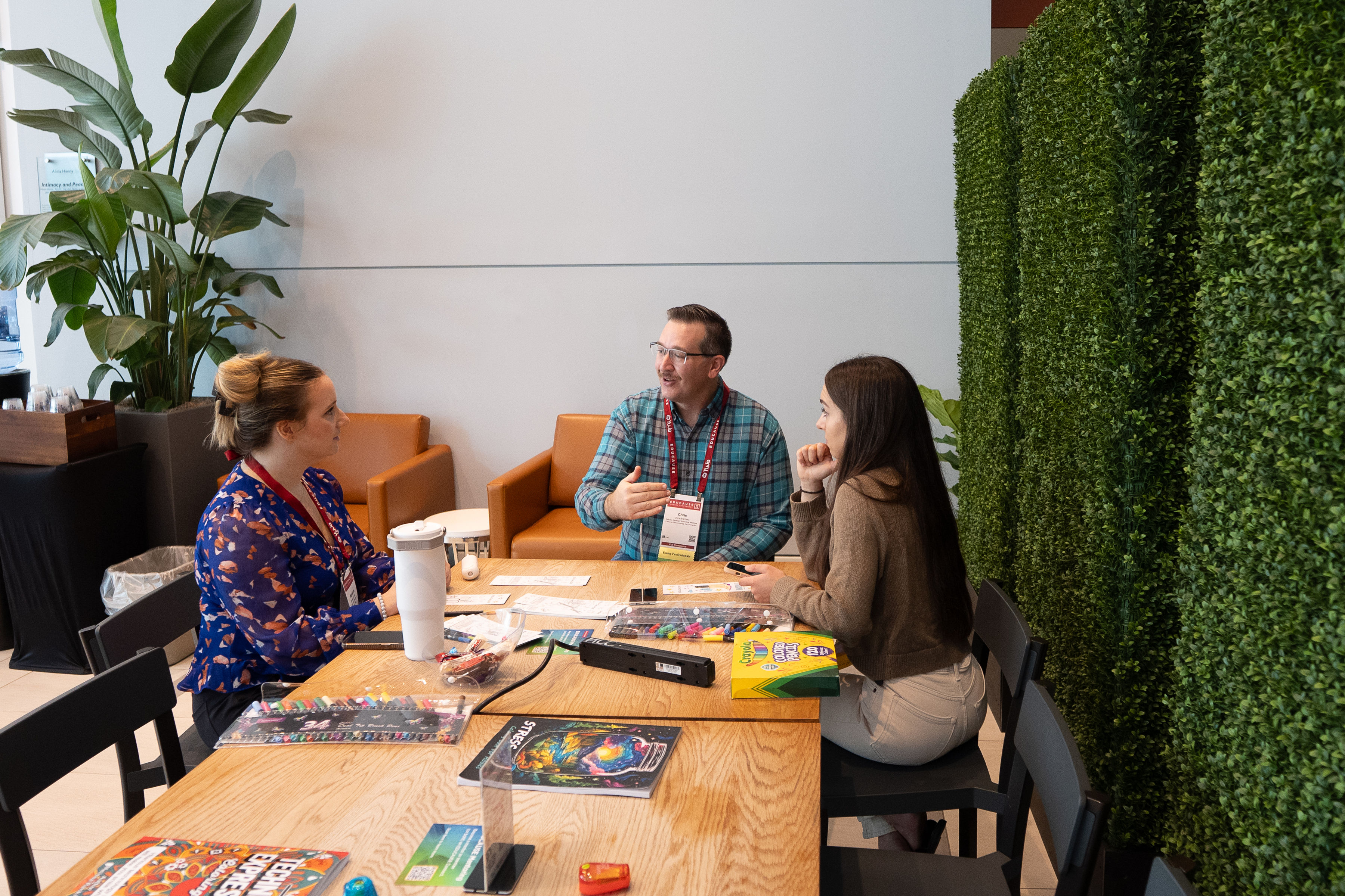 3 people meeting at a table.